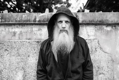 Portrait of man looking away against wall