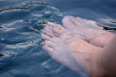 Close-up of person hand in water