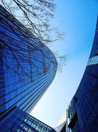 Low angle view of modern buildings against clear blue sky