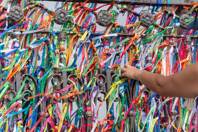 Severed hand of a person holding souvenir ribbons