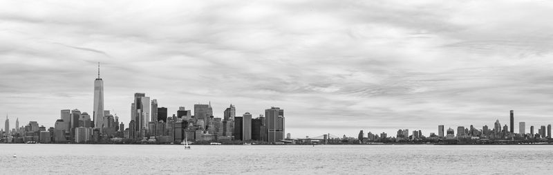 View of cityscape against cloudy sky