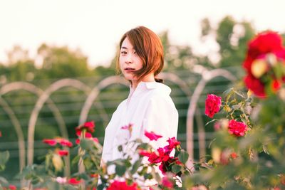 Portrait of woman holding plant