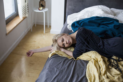 Woman sleeping on bed at home