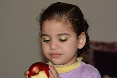 Close-up of girl with apple