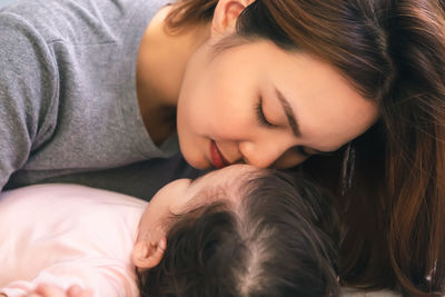 High angle view of girl sleeping on bed