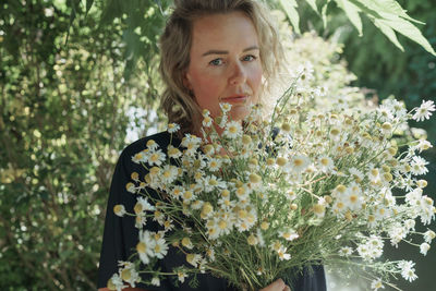 Portrait of woman with pink flowers