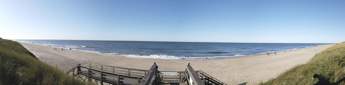 Panoramic view of beach against clear sky