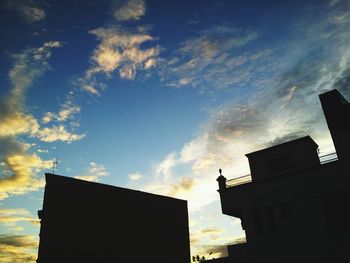 High section of building against sky at sunset