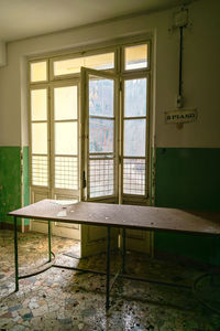 Empty chairs and table in building