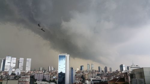 Cityscape against cloudy sky