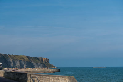 Scenic view of sea  and coast with mulberry against sky