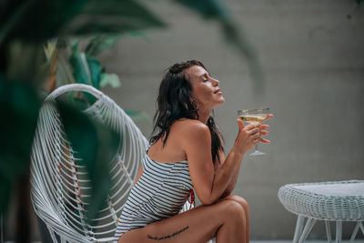 Full length of a young woman drinking water