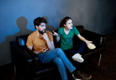 Young couple sitting on sofa