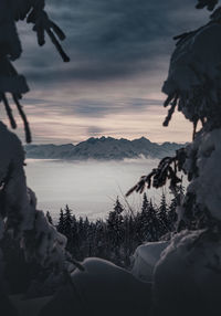 Scenic view of snowcapped mountains against sky during sunset