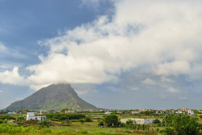 Scenic view of landscape against cloudy sky