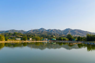 Scenic view of lake against clear blue sky