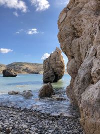 Rocks on sea shore against sky