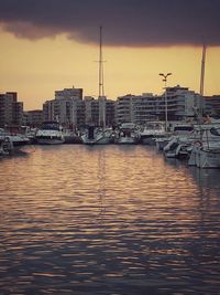 Boats in harbor at sunset