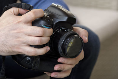 Midsection of man photographing with camera