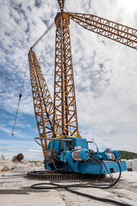 Old soviet crane on the slewing gear in an abandoned marble quarry. high boom crane.