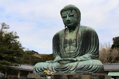 Statue of buddha against sky