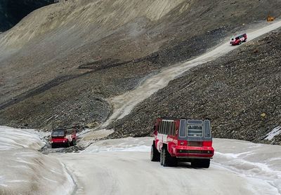 Vehicles on road against mountain