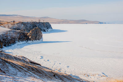 Scenic view of beach against sky during winter