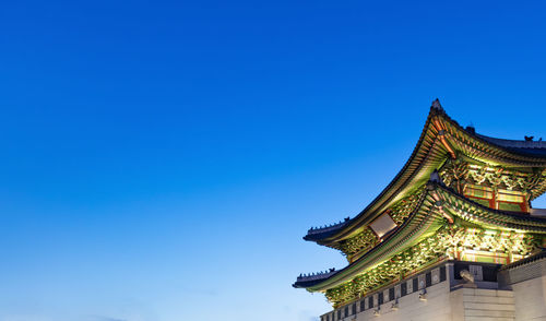 Low angle view of building against clear blue sky