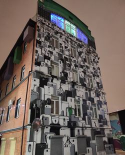 Low angle view of illuminated building against sky