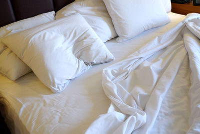 High angle view of messy bed