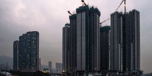 Low angle view of buildings against sky at dusk