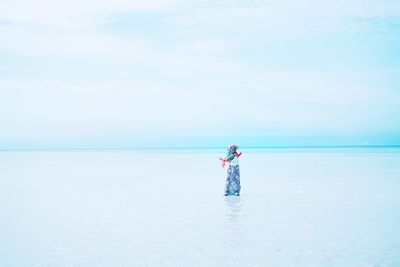 Man standing on beach against sky