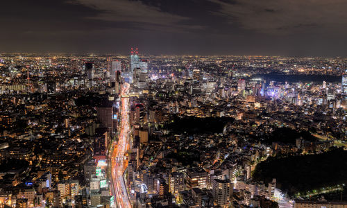 High angle view of city lit up at night