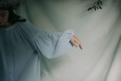 Woman standing in front of curtain