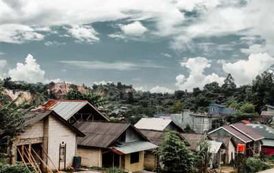 High angle view of houses and trees against sky