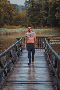 Portrait of man standing on footbridge