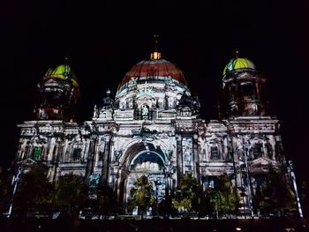 Low angle view of illuminated cathedral against sky at night