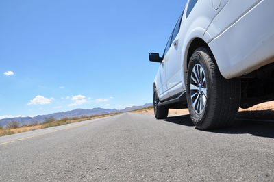 View of road on desert against blue sky