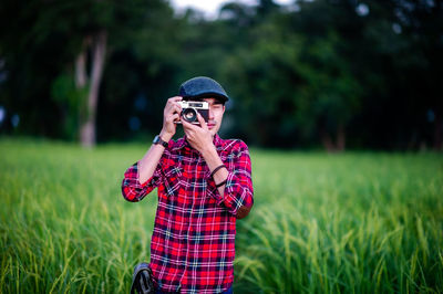 Man wearing sunglasses standing on field