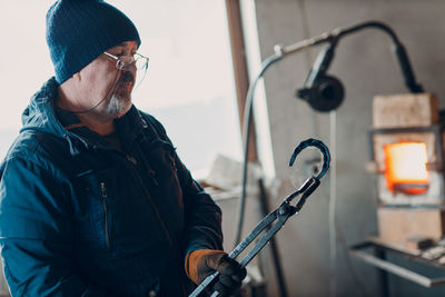 Side view of man working in factory