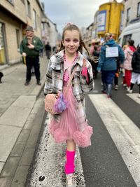 Portrait of young woman walking on street