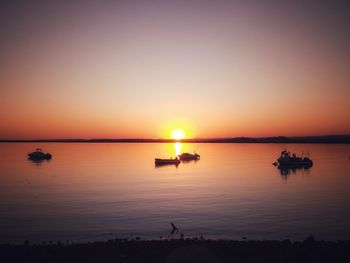 Scenic view of sea against romantic sky at sunset