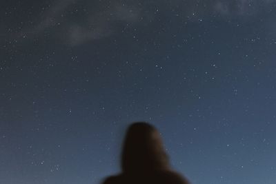 Silhouette woman against sky at night