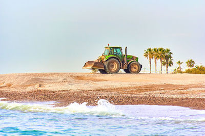 Tractor on the beach to clean the sand in the vacation area. maintenance