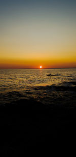 Scenic view of sea against clear sky during sunset