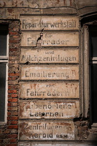 Low angle view of text on wall of old building