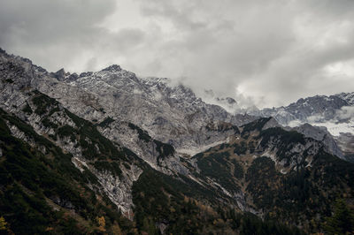 Scenic view of mountains against cloudy sky