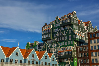 Low angle view of buildings in town against sky