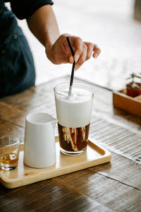 Midsection of coffee cup on table