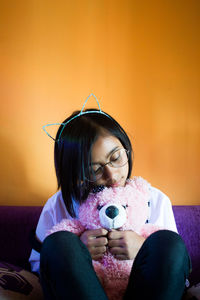 Close-up of young woman holding eyeglasses